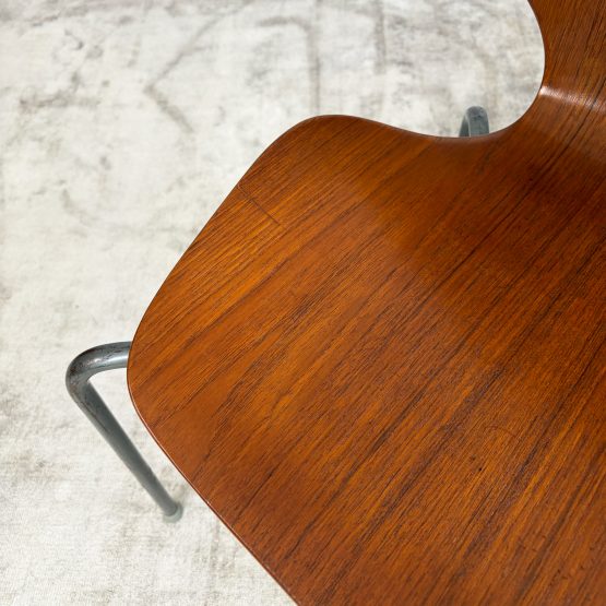 Pair of 1950s Danish teak plywood chairs by Herbert Hirche for Jofa Stålmøbler, with sculptural moulded seats and original tubular steel frames.